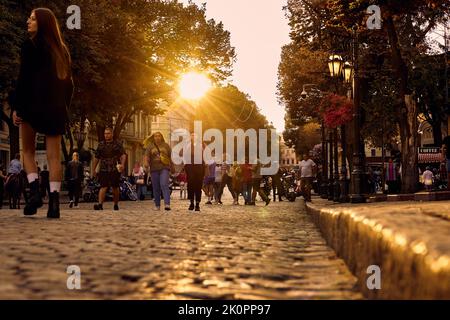 Sonnenuntergang und Menschen auf der zentralen Straße der Stadt Deribasovskaya in Odessa, Ukraine. Stockfoto