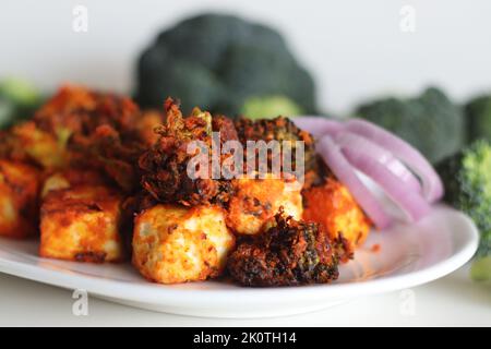 Tandoori Paneer Brokkoli. Quark-Würfel und Brokkoli-Röschen, mariniert mit Joghurt und Gewürzen und gebraten. Gesunde Vorspeise oder ein abendlicher Schnüpfer Stockfoto