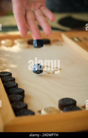 Backgammon Board mit Chips und Würfeln im Flug Stockfoto