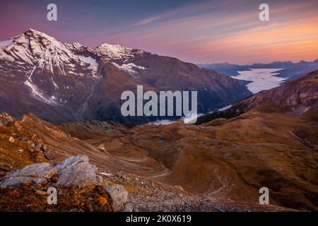 Nebeliges Tal von oben Großglockner und Berglandschaft bei Sonnenaufgang, Österreich Stockfoto