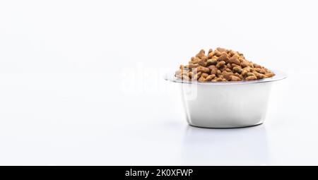 Trocknen Sie granuliertes Futter in einer Metallschale für Katzen und Hunde. Tierpflege, Vitamine und ausgewogene Tierernährung. Hochwertige Fotos Stockfoto