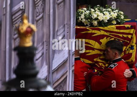 Die Bearer Party von Queen's Company, 1. Bataillon Grenadier Guards, trägt den Sarg von Queen Elizabeth II. In die Westminster Hall, London, wo er vor ihrer Beerdigung am Montag in einem Zustand liegen wird. Bilddatum: Mittwoch, 14. September 2022. Stockfoto