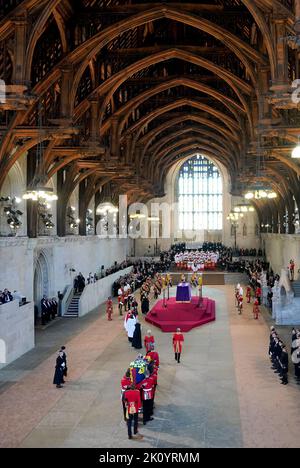 Die Bearer Party von Queen's Company, 1. Bataillon Grenadier Guards, trägt den Sarg von Queen Elizabeth II. In die Westminster Hall, London, wo er vor ihrer Beerdigung am Montag in einem Zustand liegen wird. Bilddatum: Mittwoch, 14. September 2022. Stockfoto