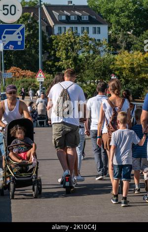 Fußgänger und E-Scooter auf einem Bürgersteig, sich gegenseitig in die Nähe kommen, illegales Fahren auf dem Bürgersteig durch E-Scooter-Nutzer, Düsseldorf, NRW, Stockfoto