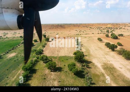 Blick auf die wunderschöne Landschaft der Thar-Wüste aus einem Flugzeug, Rajasthan, Indien. Die Propeller und Thar wüsten im Rahmen. Spiel von Sonnenlicht und Klo Stockfoto