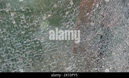 Zerbrochenes Glasfenster durch Explosionssplitter. Zerbrochenes Glas. Abstrakt verschwommen Unschärfe gebrochen Glas Textur Hintergrund. Abstrakter Hintergrund Stockfoto