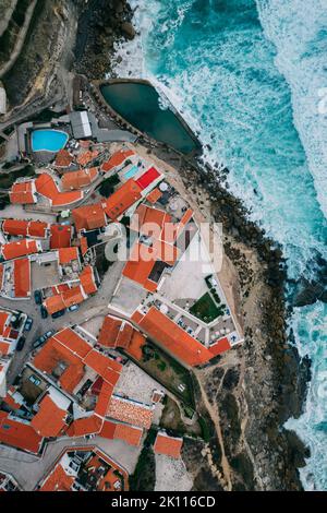 Luftaufnahme von Azenhas do mar von oben, Blick auf das rote Dach einer kleinen Stadt entlang der portugiesischen Küste mit Blick auf den Atlantischen Ozean, Colares, Portugal Stockfoto