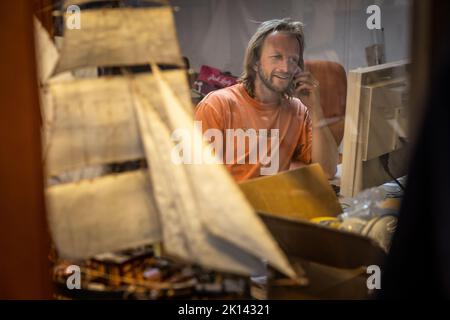 Kapitän Andreas Lackner, Gründer der Reederei 'Fairtransport', hier in seinem Büro im Heimathafen in Den Helder Niederlande. Hier wird sie von der Besatzung auf ihre nächste Reise vorbereitet. Der Schoner Tres Hombres transportiert Waren wie Wein, Kaffee, Schokolade und Rum aus der Karibik über den Atlantik nach Europa auf völlig klimaneutrale Weise. Stockfoto