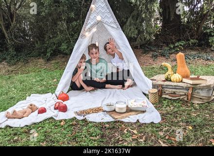 Die Kinder sind von der Wetteränderung überrascht - Sonne, Regen, Herbst Stockfoto