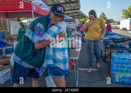 Rocklin, Kalifornien, USA. 15. September 2022. Derek Jones, eine Evakuierte aus dem Forest Hill Mobile Home Park, umarmt Lynda Hogge aus Woodland, nachdem sie am Donnerstag, den 15. September 2022 in Rocklin, die Lieferungen für Mosquito Fire Evakuierte in Lot B des Sierra College abgesetzt hatte. Hogge sagt, dass sie vier Hausbrände überlebt hat und versteht, was die Feueropfer durchmachen. Jones hat in dem Zentrum, in dem die Menschen campen, geholfen, um ihre Hunde zu behalten und sie nicht in ein Tierheim zu bringen. (Bild: © Renée C. Byer/ZUMA Press Wire) Stockfoto