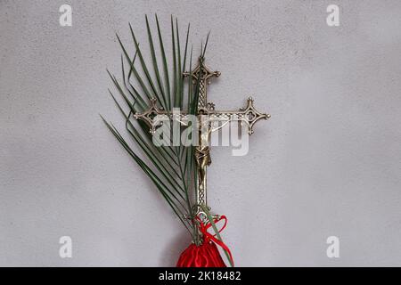 Karwoche. Prozessionskreuz und Zweige. Traditionelle katholische Feier Palmsonntag. Christlicher Glaube. Religiöses Symbol. Stockfoto