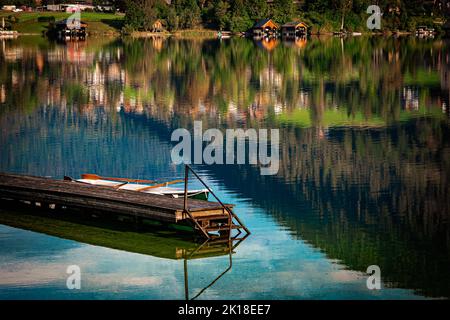 Schöner Blick auf einen hölzernen Steg am alpinen Altausseer See im Ausseer Land, Steiermark, Österreich, und ein verankertes Ruderboot Stockfoto