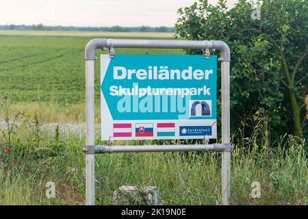 Deutsch Jahrndorf, Österreich - 1. Juni 2022: Richtungsschild zum Grenzpunkt von Ungarn, Österreich und der Slowakei. Stockfoto