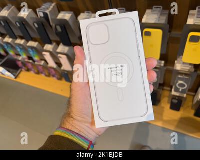 Paris, Frankreich - 16. Sep 2022: POV männliche Handhaltepaket im Apple Store mit dem neuen iPhone 14 Plus mit durchsichtiger Tasche MagSafe Charging Stockfoto