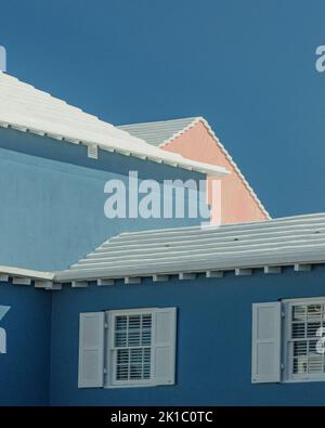 Bermuda-Architektur Bunte blaue und rosarote Häuser mit weißen Dächern und Fensterläden aus nächster Nähe Stockfoto