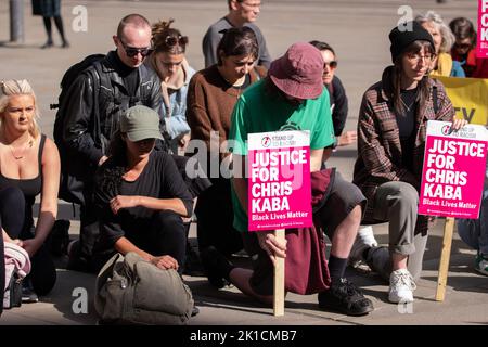 Manchester, Großbritannien. 17. September 2022. Die Protestierenden nehmen das Knie. Demonstranten auf dem Manchester St. Peters Square versammeln sich zum National Day, um auf Chris Kaba, 24, aufmerksam zu machen, der am 5.. September von einer bewaffneten Met Police Einheit nach einer Verfolgungsjagd in Streatham, Süd-London, getötet wurde. Eine Untersuchung durch das unabhängige Büro für Polizeiverhalten ergab, dass er nicht bewaffnet war. Sobald der IOPC seine Ermittlungen abgeschlossen hat, kann es zu einer weiteren Verzögerung kommen, während die Staatsanwälte entscheiden, ob sie Anklage erheben oder nicht. Wenn keine Anklagen folgen, wird mit einer Untersuchung gerechnet, die auch als Inquest in die de dienen wird Stockfoto