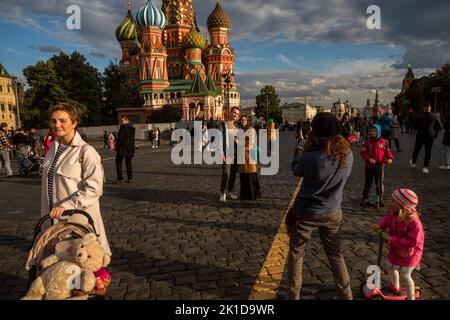 Moskau, Russland. 17.. September 2022. An einem sonnigen Herbsttag, Russland, laufen die Menschen auf dem Roten Platz vor dem Hintergrund der Basilius-Kathedrale und des Kremls im Zentrum von Moskau Stockfoto