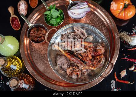 Braten Kopf eines Lammes. Traditionelles türkisches Offalgericht Kelle Sogus, Lammkopffleisch mit Brain Servierportion auf einem Kupferteller. Stockfoto