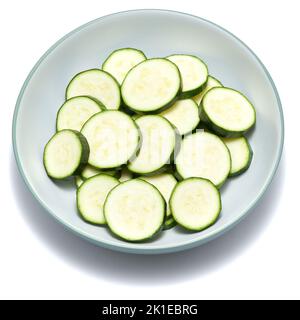 In Scheiben geschnittene Zucchini-Kreise in Keramikschale isoliert auf weißem Hintergrund Stockfoto