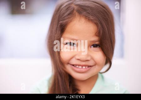 Scheut so eine Cutie. Portrait eines niedlichen kleinen Mädchens mit einem strahlenden Lächeln. Stockfoto