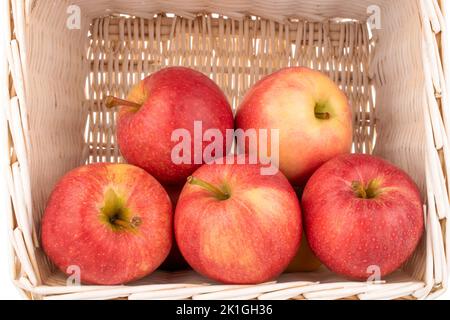 Mehrere saftige rote Äpfel in einem Korb, Makro. Stockfoto