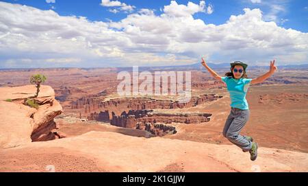 Junge Mädchen Touristen springen glücklich in Canyonlands National Park, Utah, USA Stockfoto