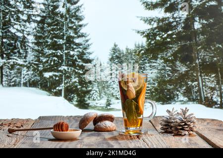 Design für Tapeten. Stillleben im Herbst oder Winter mit heißem Tee mit Früchten, Beeren und Gewürzen in einer Glasschale. Gesunde aktive Lebensweise, Urlaub, liric Stockfoto