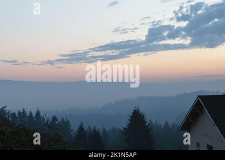 In den frühen Morgenstunden des 19. September 2022 hängt eine Kombination aus Nebel und Rauch vom Cedar Creek Fire über Eugene, Oregon. Stockfoto