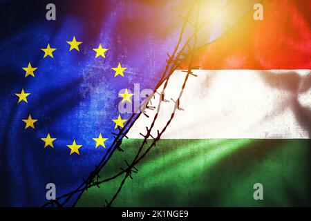 Grunge Flaggen der EU und Ungarn geteilt durch Stacheldraht Illustration Sonne Dunst Sicht, Konzept der angespannten Beziehungen zwischen und Streit der Europäischen Union und H Stockfoto