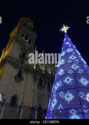 Schöner Weihnachtsbaum voller Sterne, der vor der Kathedrale von Jaen in der Nacht in Spanien steht. Weihnachtszauber und Seele. Hochwertige Fotos Stockfoto