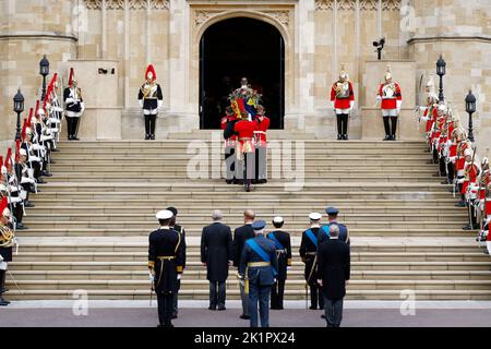 König Charles III, die Prinzessin Royal, der Herzog von York, der Graf von Wessex, der Prinz von Wales, der Herzog von Sussex, Peter Phillips, der Graf von Snowden, Der Herzog von Gloucester und der Vizeadmiral Sir Tim Laurence sehen zu, wie Sargträger den Sarg von Königin Elizabeth II. In die St. George's Chapel in Windsor Castle, Berkshire, tragen, während er für den Einbindungsservice ankommt. Bilddatum: Montag, 19. September 2022. Stockfoto