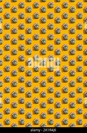 Orangefarbener Kunsthintergrund. Haus nahtloses Muster. Einrichtung für Weihnachtsfeiern. Grün weiß Märchen Hause festliche Komposition isoliert auf hellem Gelb. Stockfoto