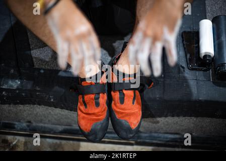 Kletterschuhe und Hände mit weißem Magnesiumpulver bedeckt Stockfoto