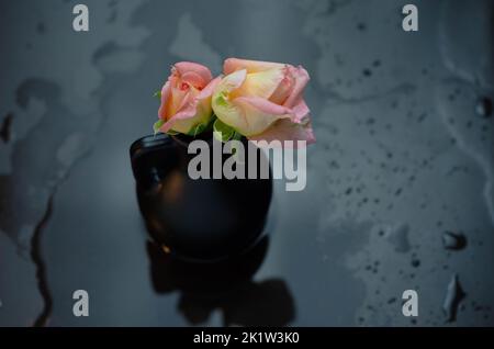 Flammende Rosenblüte auf dunkelrotem Hintergrund. Liebeskonzept mit Blume und Feuer. Kreative Natur Idee zum Valentinstag oder Frauentag. Stockfoto