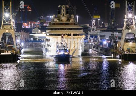 Hamburg, Deutschland. 21. September 2022. Die Luxusyacht 'Dilbar' wird von Schleppern vom überfluteten Trockendock der Werft Blohm Voss auf die Elbe vor den Landebrücken geschleppt. Um das Trockendock 'Elbe 17' in Hamburg für die Reparatur anderer Schiffe freizumachen, wird die Yacht ohne eigene Motorleistung per Schlepper zu einem anderen Liegeplatz in Bremen geschleppt. Die Luxusyacht „Dilbar“ wurde im April 2022 aufgrund von EU-Sanktionen aufgrund der Invasion russischer Truppen in der Ukraine festgenommen. Quelle: Jonas Walzberg/dpa/Alamy Live News Stockfoto