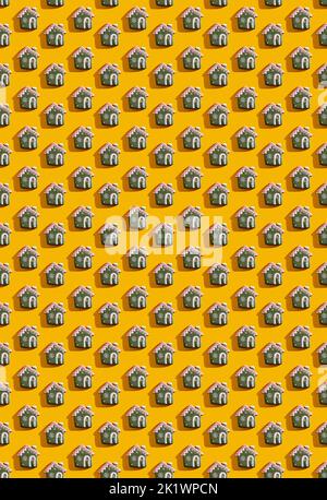 Orangefarbener Kunsthintergrund. Haus nahtloses Muster. Einrichtung für Weihnachtsfeiern. Grün weiß Märchen Hause festliche Komposition isoliert auf hellem Gelb. Stockfoto