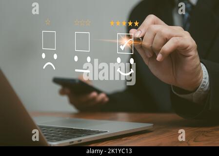 Geschäftsleute nutzen Laptop-Computer Umfrage und bewerten Zufriedenheit geben eine 5-Sterne-Form auf einem virtuellen digitalen Bildschirm Zufriedenheit Bewertung. Umfragekonzept. Stockfoto