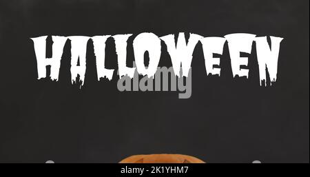 Bild von halloween Text über geschnitztem Kürbis auf schwarzem Hintergrund Stockfoto