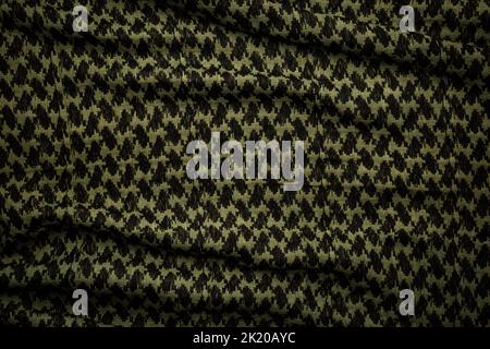 Keffieh Schal. Die Textur des traditionellen Baumwoll-symbolischen arabischen Schals. Khaki Hintergrund. Stockfoto