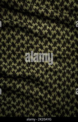 Keffieh Schal. Die Textur des traditionellen Baumwoll-symbolischen arabischen Schals. Khaki Hintergrund. Stockfoto