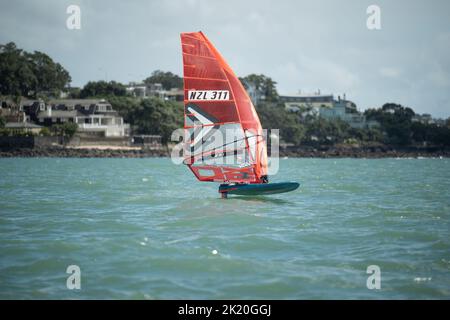 Ein Mann nimmt an einem nationalen Windsurf-Hydrofoil-Rennen beim Waterbourne Watersports Festival, Takapuna Beach, Auckland, Neuseeland, Teil. Stockfoto