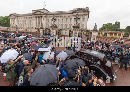 Menschenmassen warten vor den Toren des Buckingham Palace, bis sie im Regen ankommen. Die Nation trauert weiterhin um den Tod von Königin Elizabeth II. Bildaufnahme Stockfoto