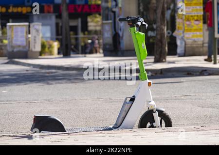 Ein elektrischer Motorroller parkte auf der Straßenseite im Stadtzentrum Stockfoto