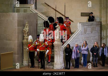 Die Wachablösung findet statt, wenn Mitglieder der Öffentlichkeit, die sich durch die Nacht anstellen, am Sarg Ihrer Majestät Königin Elizabeth II. Vorbeilaufen Stockfoto