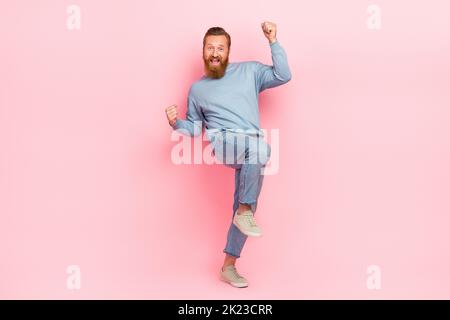 In voller Länge Porträt von überglücklich zufrieden Person heben Fäuste Erreichung isoliert auf rosa Hintergrund Stockfoto