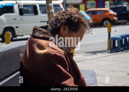 La Paz, Bolivien - September 11 2022: Älterer bolivianischer Mann schläft auf einer Bank auf dem Platz in der Nähe der Seilbahn Stockfoto