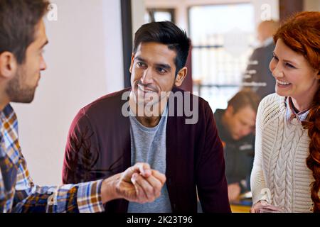 Arbeiten mit ihren Ideen. Ein Team junger Designer diskutiert ihre Arbeit. Stockfoto