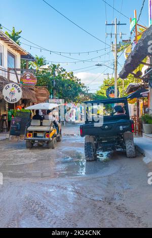 Holbox Mexiko 22. Dezember 2021 Golfwagen Buggy Autos Karren auf schlammigen Straße im Dorf auf Holbox Insel Mexiko. Stockfoto