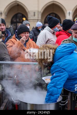 Krakau, Polen - 19. Dezember 2021: Heiligabend für Arme und Obdachlose auf dem Hauptplatz in Krakau. Trotz der Covid-Pandemie, die Gruppe Kosciuszko Prep Stockfoto