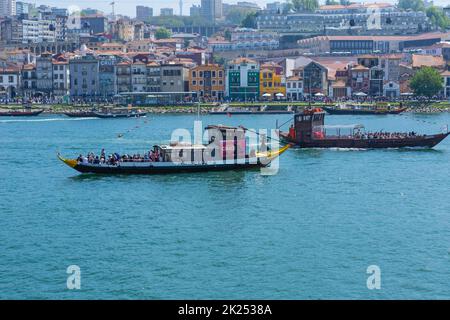 Porto, Portugal - 15. April 2022: Touristenboote und historische Gebäude der Ribeira-Gegend am Douro-Fluss in der europäischen Stadt Porto Stockfoto